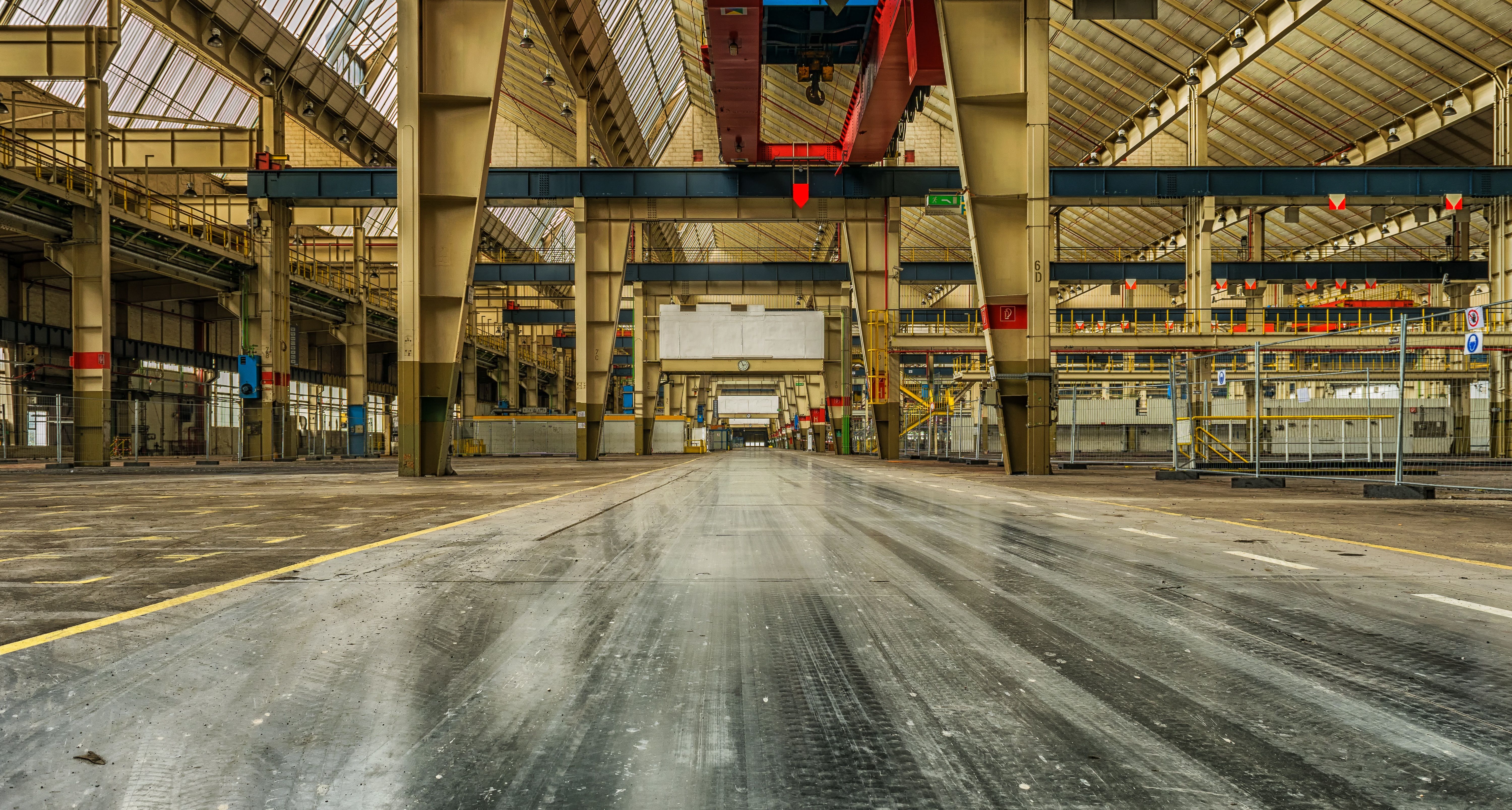 Wide view of a modern factory interior with industrial machinery and conveyor systems