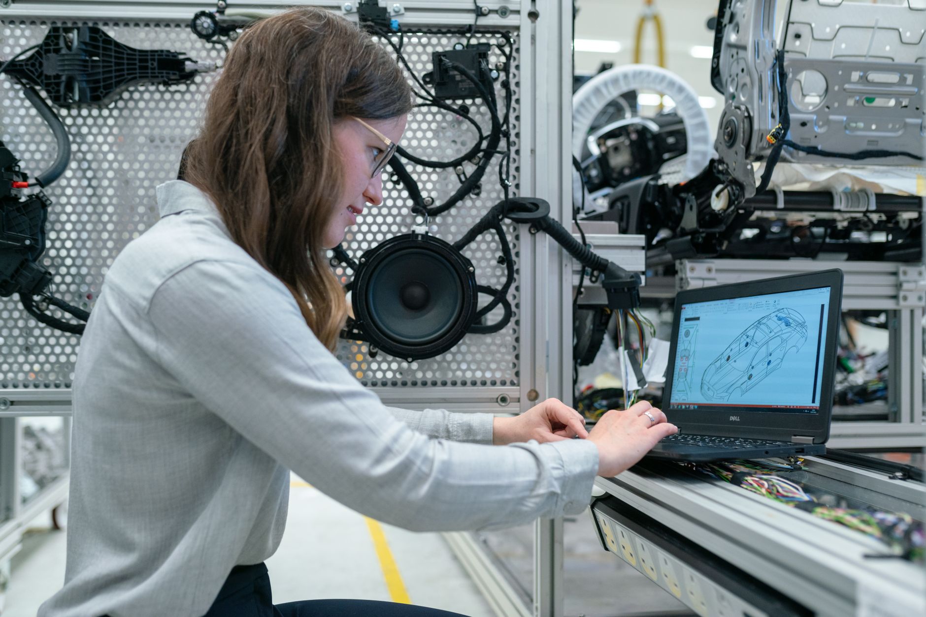 Engineer conducting research with lab equipment and a laptop