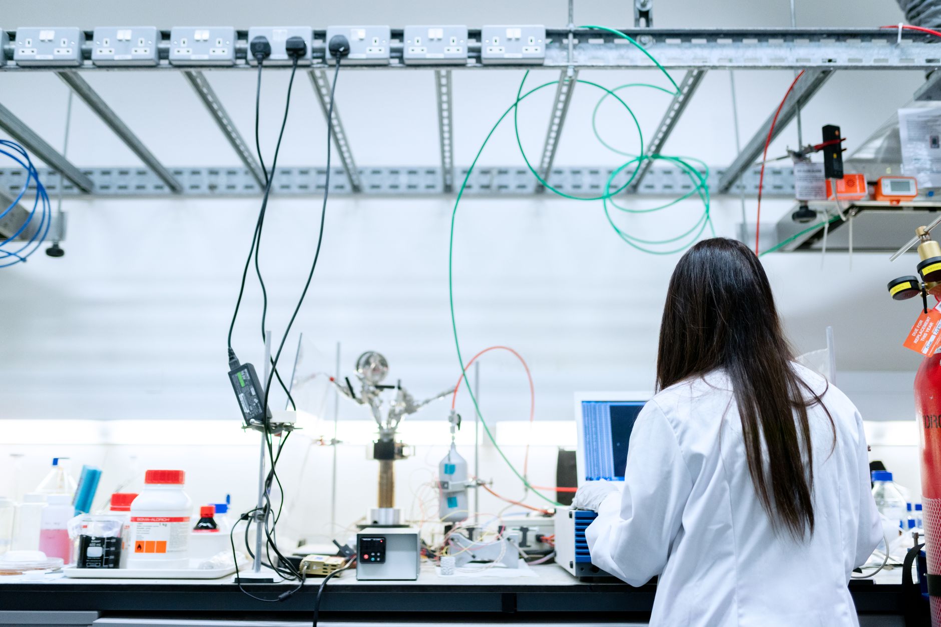 Researcher working with test equipment in a modern laboratory