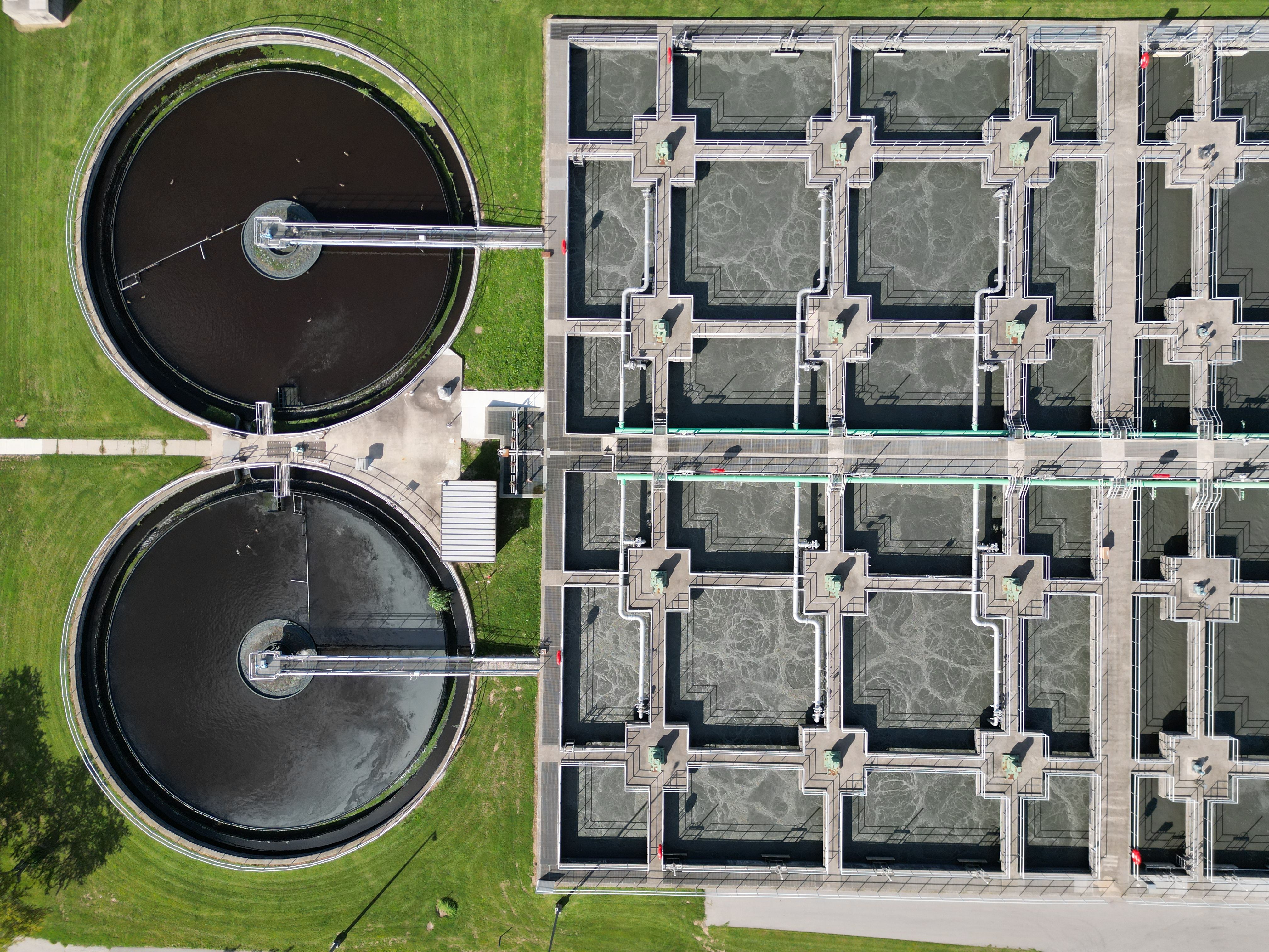 Drone view of a circular municipal wastewater treatment plant in winter snow